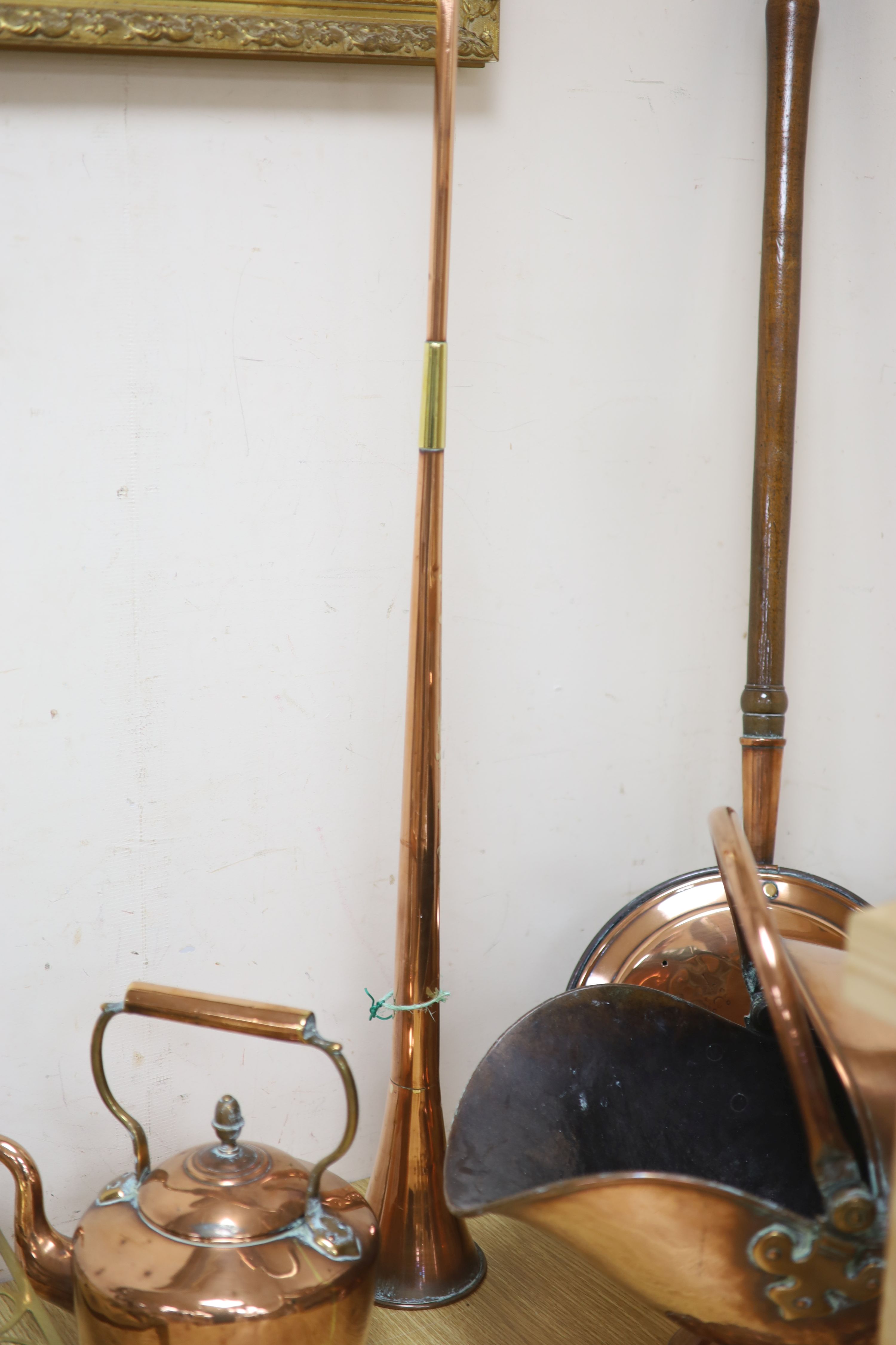 A Victorian copper coal helmet, A Victorian copper kettle, a Victorian copper coaching horn and sundry metalware